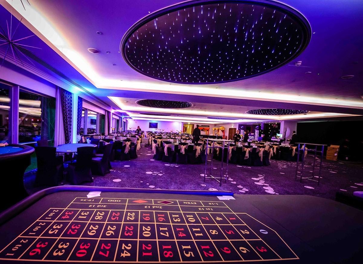 Casino tables under a star-lit ceiling at a Vegas-themed party